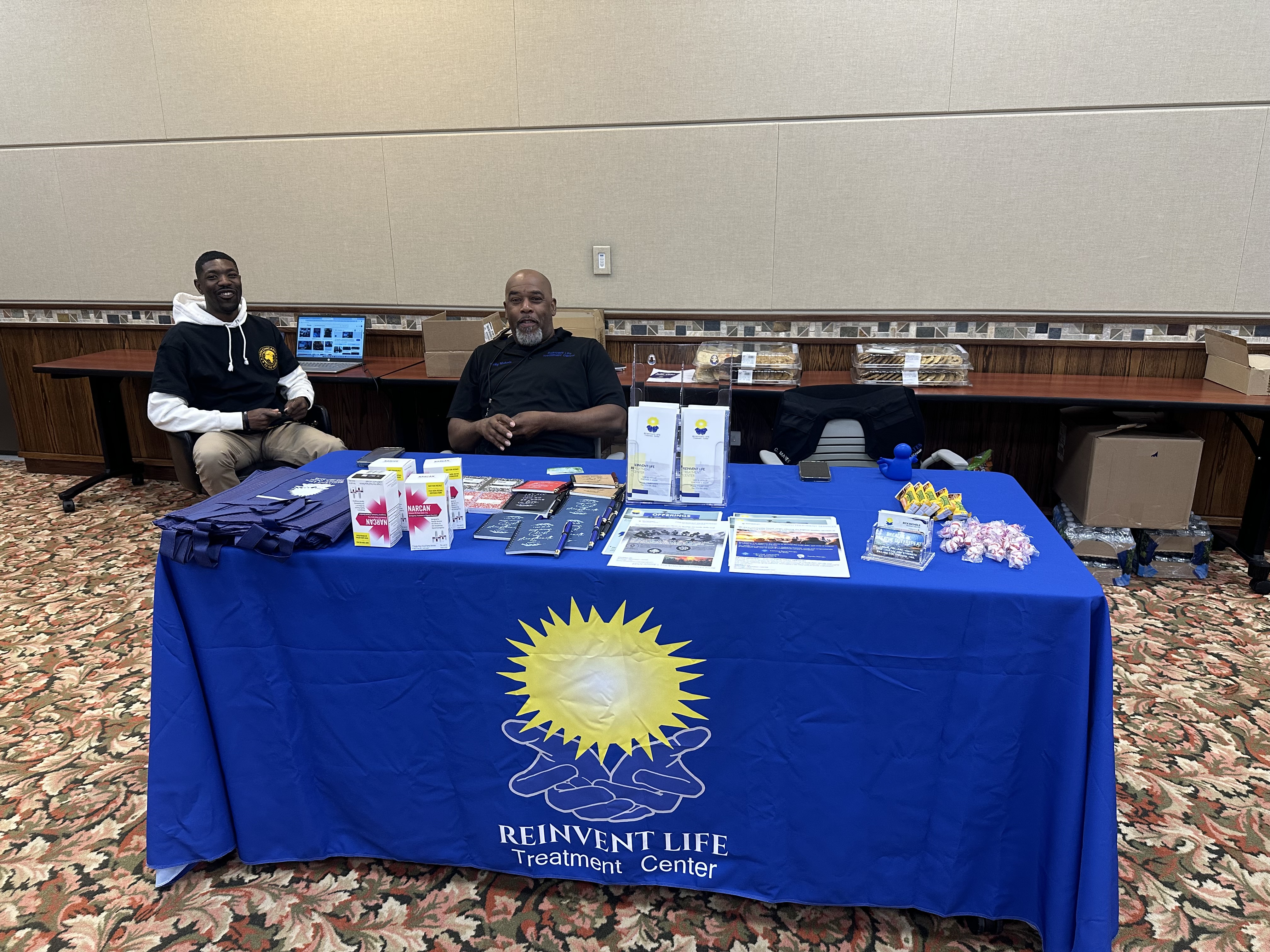 Reinvent Life staff at resource fair table