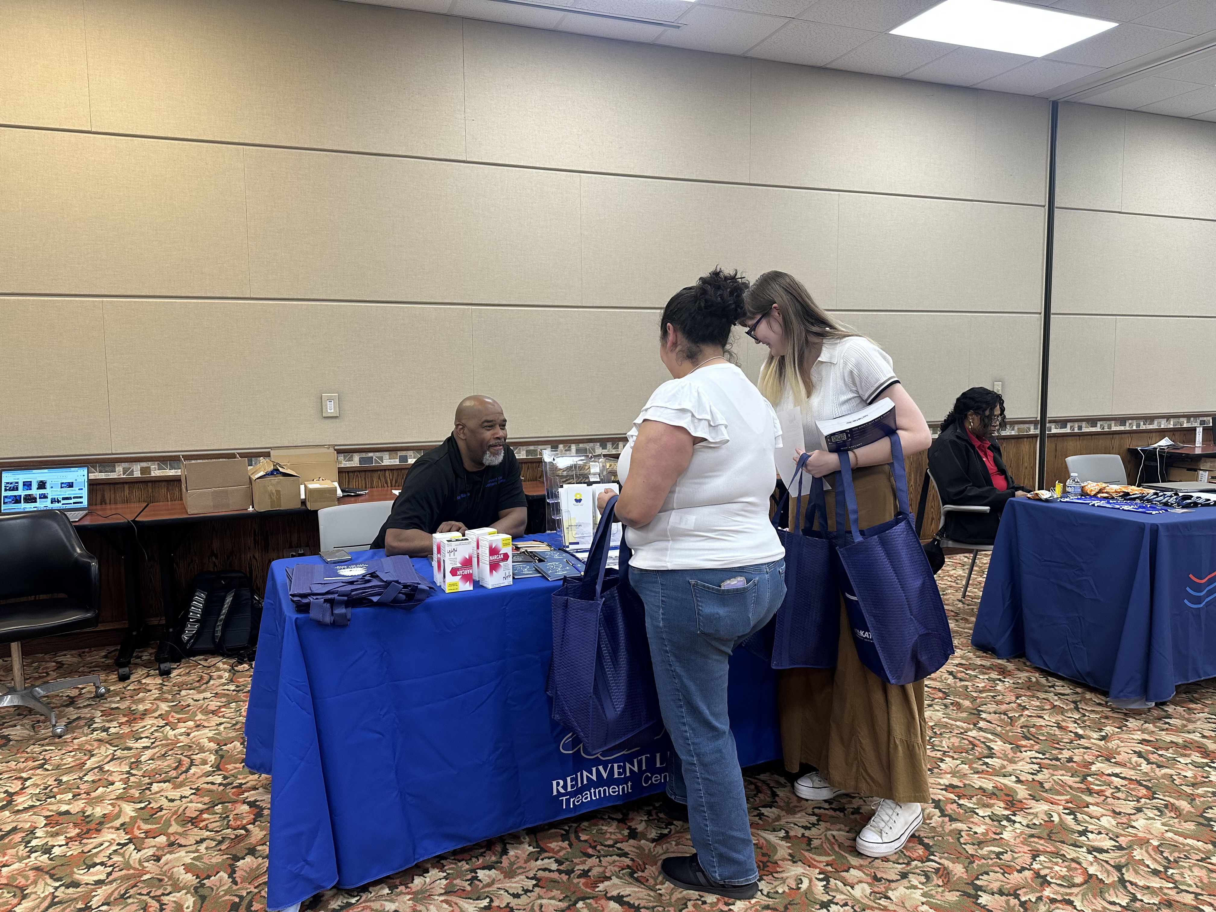 Community members at Reinvent Life booth
